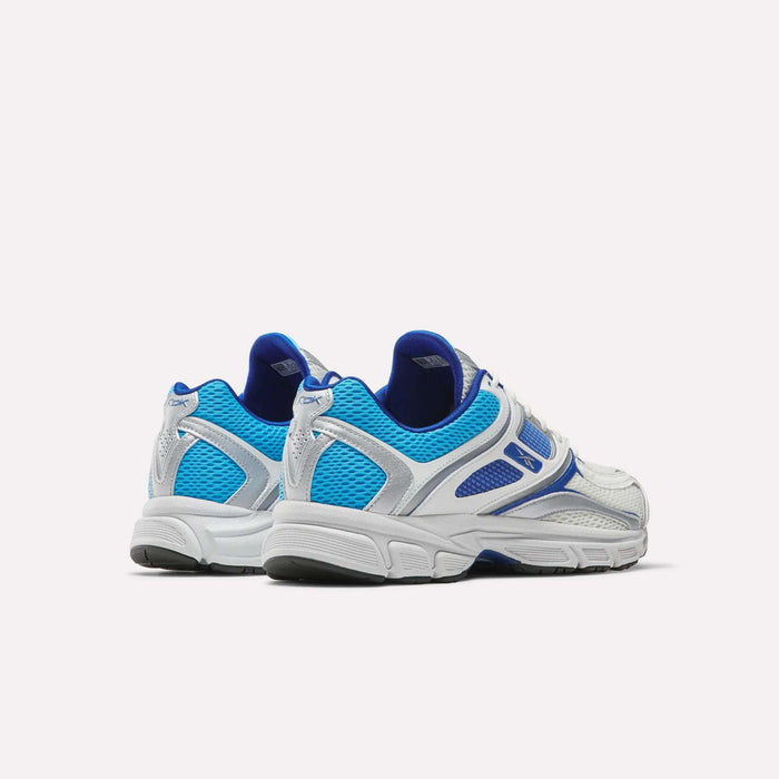 The Reebok Premier Trinity Shoes showcase a white, blue, and silver mesh design with synthetic overlays, displayed from the back and side on a plain white background. These retro tech runners deliver both style and performance.