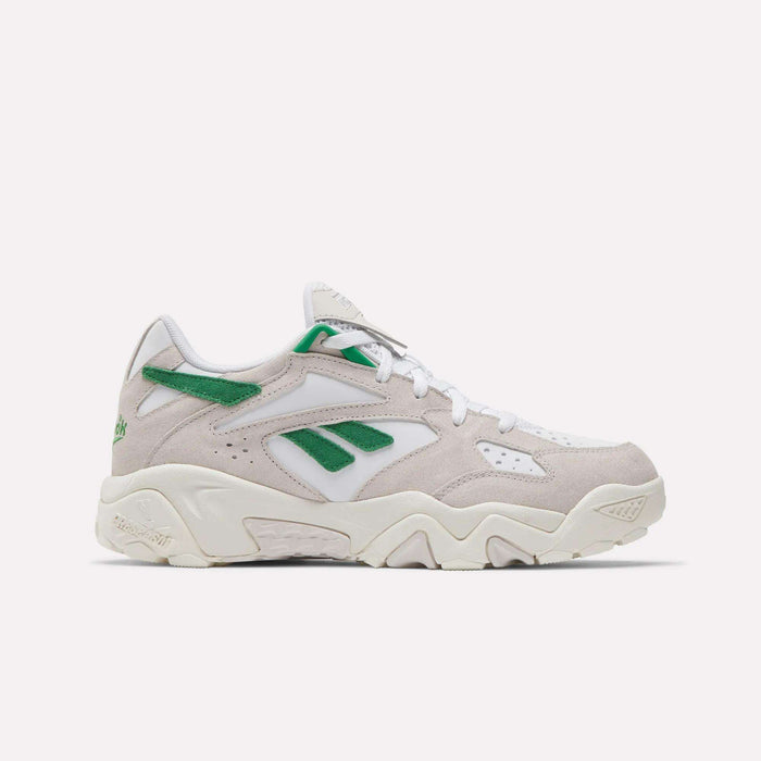 The Reebok Preseason 94 Low Retro Basketball Shoes feature a beige and white design with green accents, a chunky sole, and Reebok logos on the side and heel, inspired by '90s archive styles and shown against a plain white background.