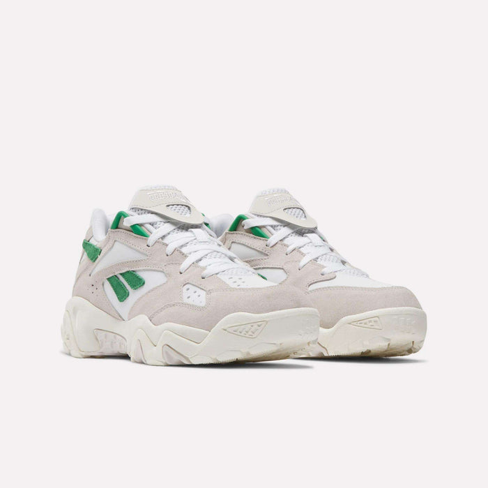 A pair of Preseason 94 Low Retro Basketball Shoes by Reebok in chunky white and beige with green accents, thick soles, and layered suede and mesh panels, inspired by '90s archive, displayed on a plain white background.