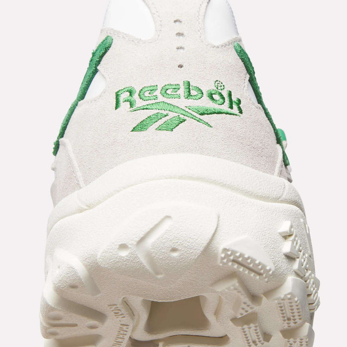 Close-up of the heel on the Reebok Preseason 94 Low Retro Basketball Shoes in white and beige, inspired by '90s athletic archives, featuring green stitching, the Reebok logo, and a textured sole.