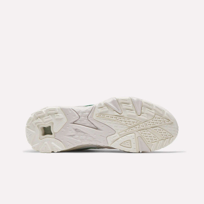 The image displays the white, textured sole of the Reebok Preseason 94 Low Retro Basketball Shoe, seen from the bottom. Geometric patterns on the sole provide traction and reflect classic '90s athletic design. The background is plain and light.