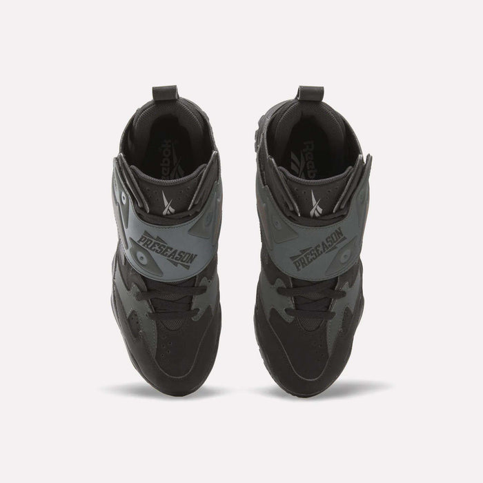 Top view of a pair of Reebok Preseason 94 Retro Basketball Shoes in black and gray with "PRESEASON" on the front straps, placed side by side on a white background.