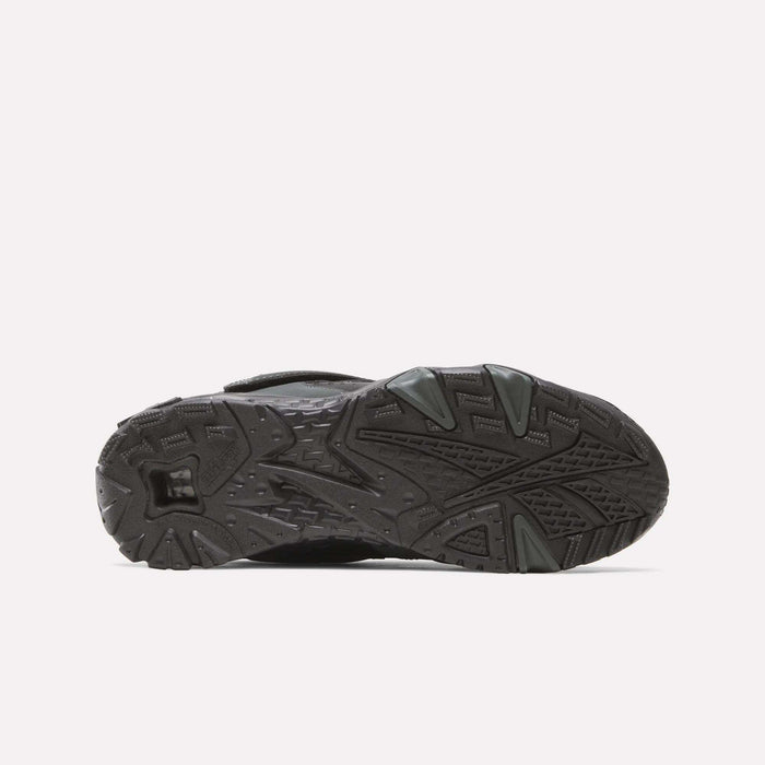 The image shows the black rubber sole of the Reebok Preseason 94 Retro Basketball Shoes, viewed from underneath, displaying textured patterns and grooves designed for traction.
