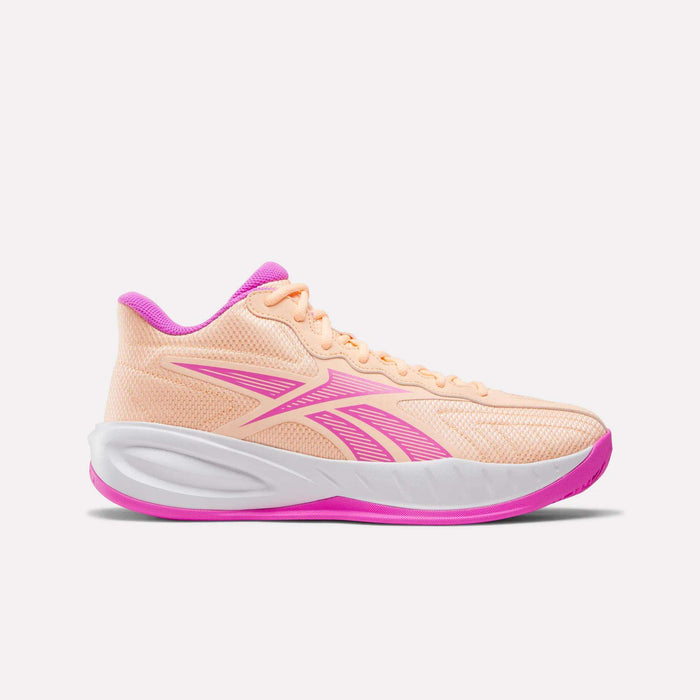 The Reebok Press Basketball Shoes feature a peach color with pink accents on the logo, sole, and lining. Designed with EVA cushioning for extra comfort, this stylish athletic sneaker is displayed on a plain white background.
