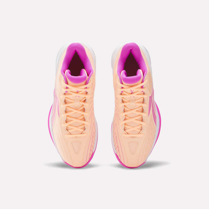 Top view of Reebok Press Basketball Shoes in peach with pink accents and white soles. Featuring EVA cushioning for comfort, these stylish and responsive shoes are side by side on a plain white background.
