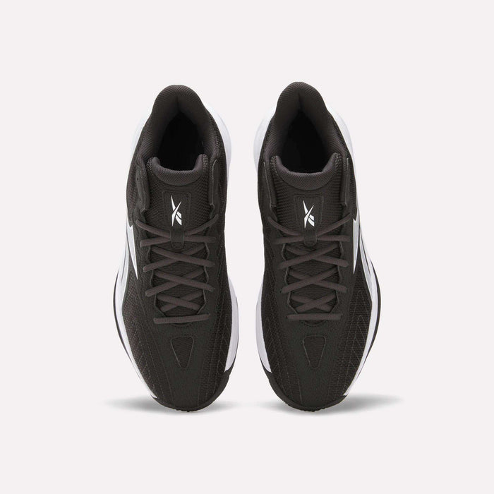Top view of Reebok Press Basketball Shoes in black with white soles and logo on the tongue, shown side by side on a white background. These shoes offer responsive comfort with EVA cushioning.