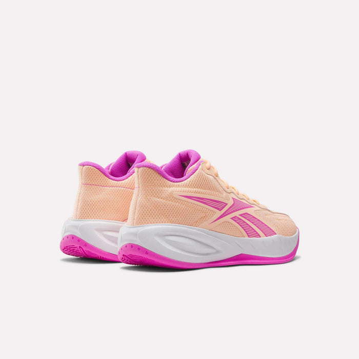 The Reebok Press Basketball Shoes in peach with pink detailing feature white midsoles, pink outsoles, and responsive EVA cushioning for all-day comfort. Shown from the back and side on a white background.