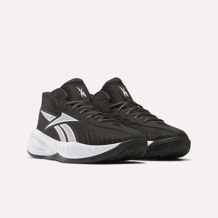 Reebok Press Basketball Shoes in black with white accents and soles, featuring a bold white side logo and EVA cushioning for comfort, are displayed against a plain light background.