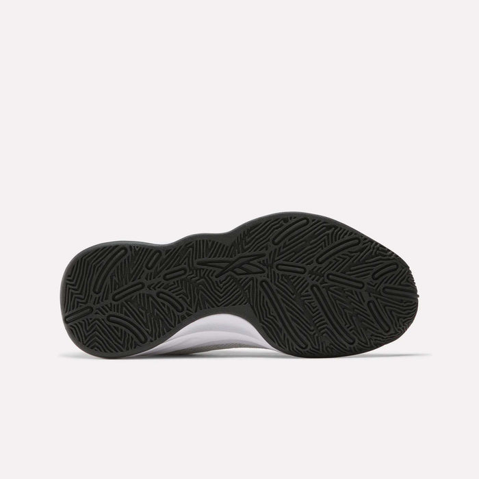 The image displays the black rubber outsole of Reebok Press Basketball Shoes, featuring a wavy, geometric tread pattern that highlights the brand's basketball heritage, photographed on a plain white background.