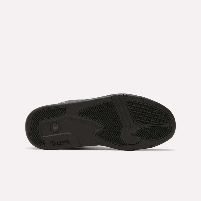 The image shows the black rubber outsole of the Reebok Pump Omni Zone II Retro Basketball Shoes, with textured grip patterns and a Reebok logo by the heel. The background is plain and light-colored.