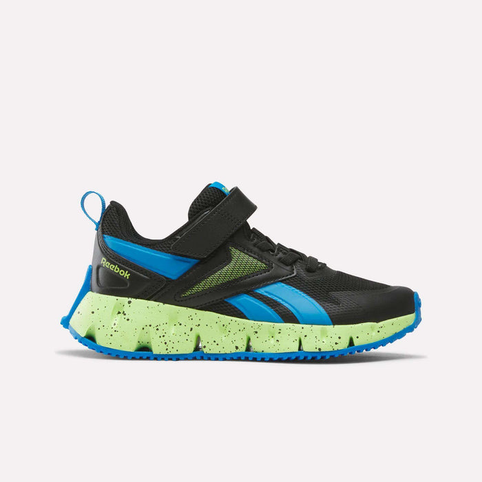 The Pyro Storm 1V Shoes for Little Kids by Reebok are shown in side profile against a plain white background. Featuring a Jet Black upper with Blue Aster accents, Lime Punch mesh details, a blue pull tab, and a chunky green speckled sole with a durable rubber outsole, these sneakers are ideal for young athletic shoe enthusiasts.