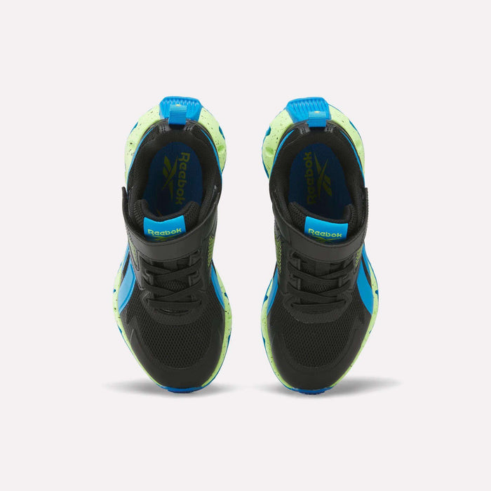 A pair of Reebok Pyro Storm 1V Shoes for little kids in black with blue and neon green accents is shown from above against a white background, highlighting the durable rubber outsole for long-lasting wear.