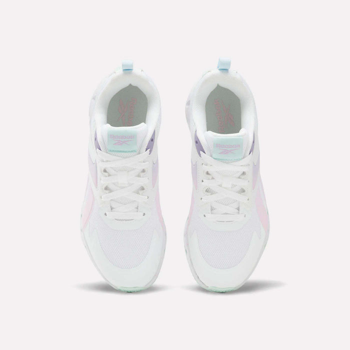 A pair of Reebok Pyro Storm Shoes for big kids in white, featuring pastel pink, purple, and mint green accents, shown from above on a plain white background. Perfect for kids seeking stylish and lightweight running shoes.