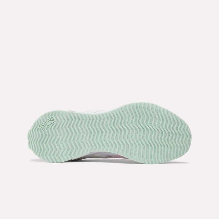 Bottom view of the Reebok Pyro Storm Shoes - Big Kids, featuring a light green sole with a wavy, zigzag tread pattern and a small Reebok logo near the heel. Designed for comfort and flexibility, these lightweight running shoes are perfect for active little feet.