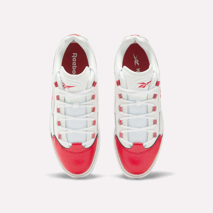 A pair of Reebok Question Golf Shoes viewed from above, showcasing white uppers with bright red accents on the toe, heel, and sides—these stylish spikeless shoes feature white laces threaded through red and white eyelets.