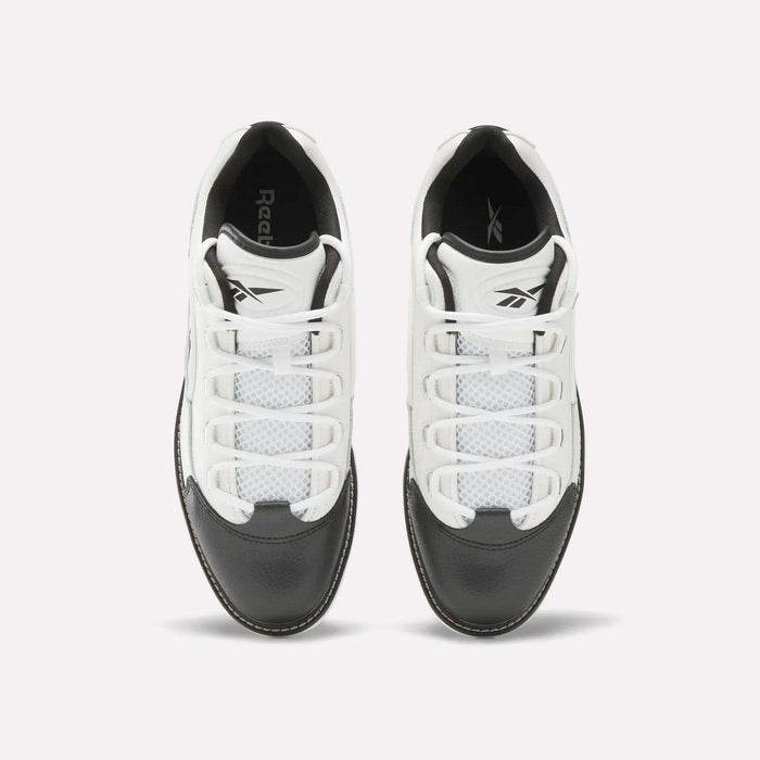 Top view of a pair of Reebok Question Golf Shoes in white and black, showcasing a premium design with white laces, black toe caps, and mesh detailing on the upper.