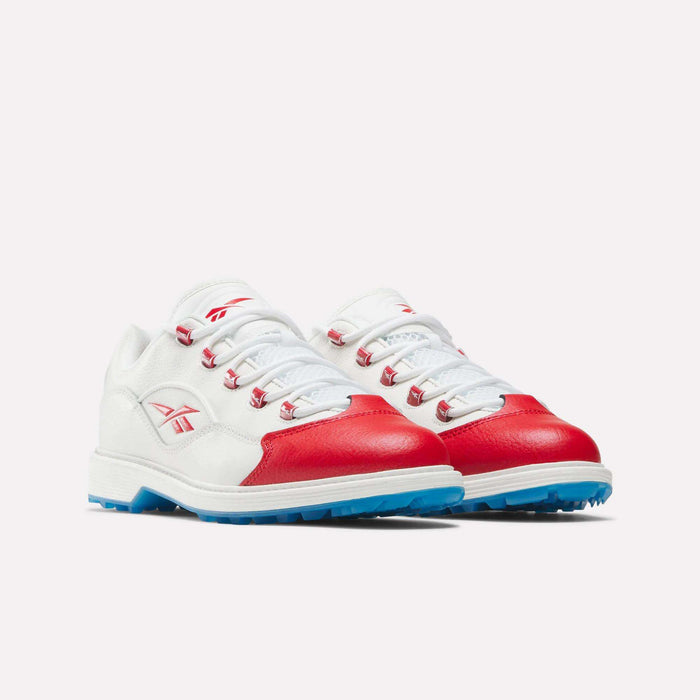 The Reebok Question Golf Shoes feature white leather with red accents on the toe and sides, blue rubber soles, and white laces, shown against a plain light background.