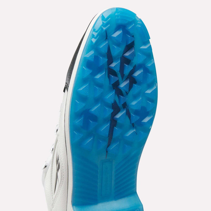 Close-up of the Reebok Question Golf Shoes reveals a vibrant blue, textured sole with a bold black line down the center. Triangular raised patterns offer spikeless grip, showcasing the premium design of these golf shoes.
