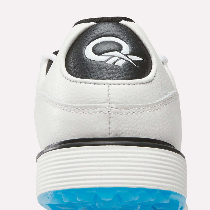 Close-up of the back of Reebok's Question Golf Shoes, a premium white sneaker with black heel detailing, white embroidered logo, ribbed white midsole, and a blue textured outsole.