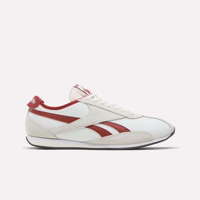 The Reebok R400 Shoes are shown from the side on a plain white background. Featuring a lace-up design, low profile, and flat sole, these sneakers come in a Chalk/Heritage Red/Vintage Chalk colorway with retro-inspired red stripes and accents, echoing the style of classic vintage footwear.