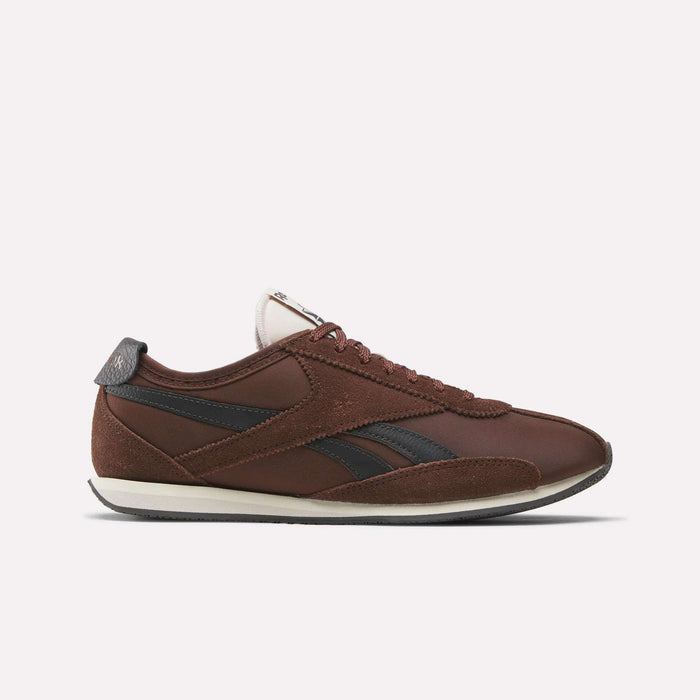 The Reebok R400 Shoes are brown low-profile sneakers with black detailing, brown laces, and a white sole, shown in profile against a plain light background, evoking classic retro track spike style.