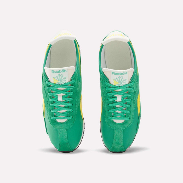 A pair of Reebok R400 Shoes in green, featuring white laces, yellow accents, a white tongue with the Reebok logo and a leaf graphic, crafted from lightweight EVA, shown from above on a plain white background.