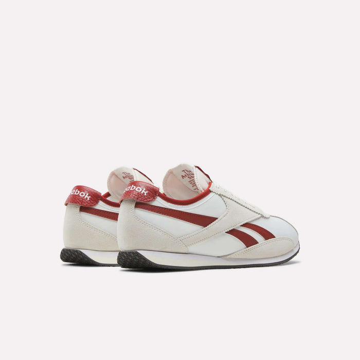 A pair of Reebok R400 Shoes in white with striking red stripes and heel accents, showcased from the back and side against a plain light background, embody a classic fusion of retro style and enduring comfort.
