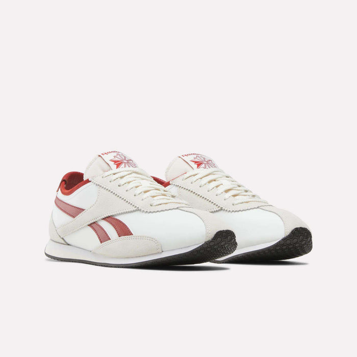 Introducing the Reebok R400 Shoes—a pair of white retro sneakers with red stripes and detailing, featuring a lace-up front and black rubber soles, displayed against a plain white background.