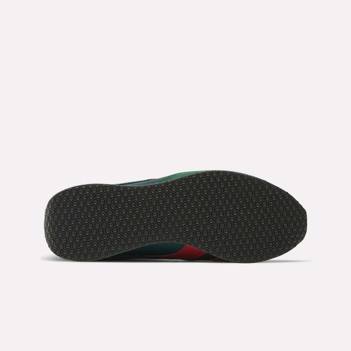 The image displays the sole of Reebok R400 Shoes, featuring a dark, flat outsole with a textured hexagonal pattern. Small hints of green and red from the upper are visible at the edge, reflecting classic retro sneaker style.
