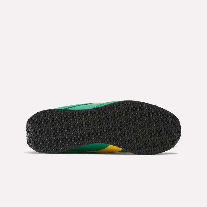 The image shows the bottom view of Reebok R400 Shoes, a low-profile sneaker with a textured black rubber sole, lightweight EVA cushioning, and green and yellow accents on the sides.