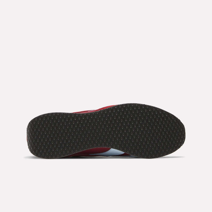 The image shows the bottom view of Reebok R400 Shoes with a black, textured circular rubber sole, and a glimpse of the red and white upper.