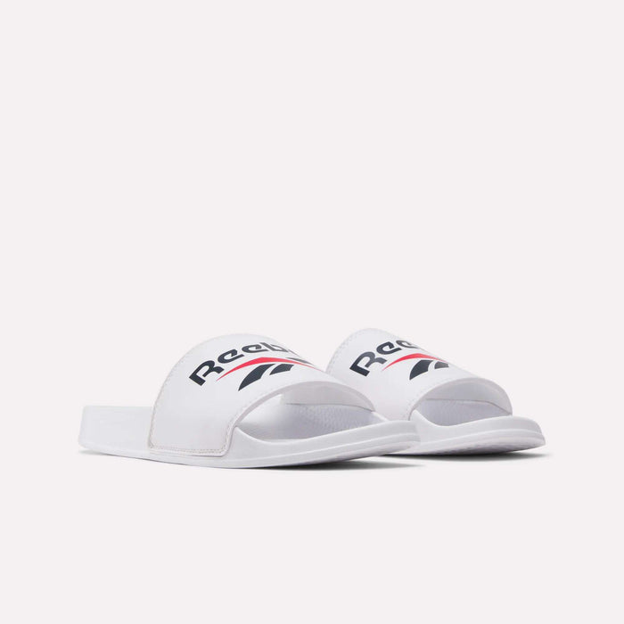 A pair of RBK Fulgere Swim Slides by Reebok, featuring white slip-on straps with the iconic black and red Reebok logo, shown on a plain white background.