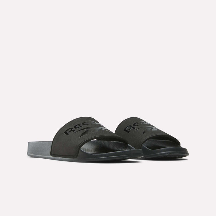 A pair of black RBK Fulgere Swim Slides by Reebok with wide logo straps, shown on a plain white background.