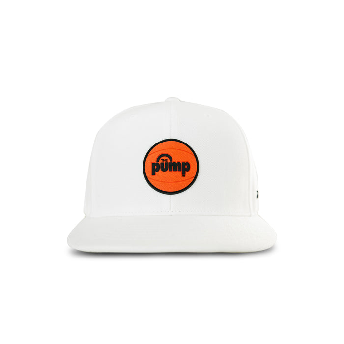 The Reebok Pump Hat by Reebok is a white flat brim cap with an orange circular "Pump" logo on the front in black text. It features an adjustable snap closure and is displayed against a plain white background.