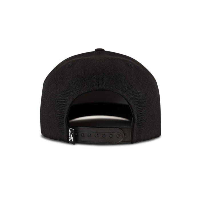 The Reebok Pump Hat by Reebok is a black snapback cap shown from the back, featuring an adjustable strap and a small black tag with white text on the left side. The background is plain white.