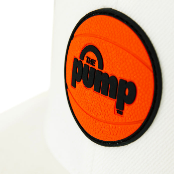 Close-up of the Reebok Pump Hat by Reebok, featuring an orange basketball patch with "THE PUMP" in bold black letters and a stylish flat brim design.