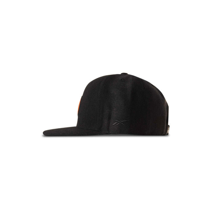 Reebok Pump Hat by Reebok, a black flat-brimmed baseball cap displayed from the side on a white background, features a subtle logo near the back.