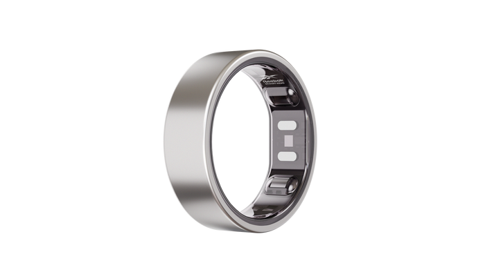 The Reebok Smart Ring, a sleek silver wearable by Reebok with visible inner-band sensors, is displayed upright against a plain white background.