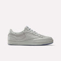 A Grey/Grey Reebok x BBC Club C 85 shoe featuring a low-top silhouette, flat sole, and lace-up closure—crafted from premium materials to celebrate Reebok’s heritage—is displayed in a side profile against a plain white background.