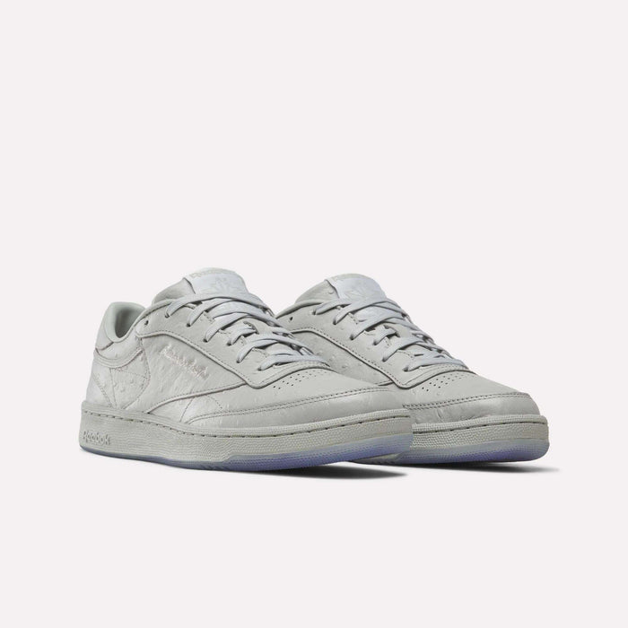 A pair of Reebok x BBC Club C 85 Shoes in light gray, designed as low-top sneakers with laces and crafted from premium materials, featuring textured leather and subtle Reebok branding, displayed against a plain white background.