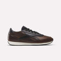 The Reebok Camargue x C.F. Stead Shoes, shown in side profile on a plain white background, feature brown full-grain leather with black accents and laces, a dark navy heel and sole detail, plus a white midsole in archival style.