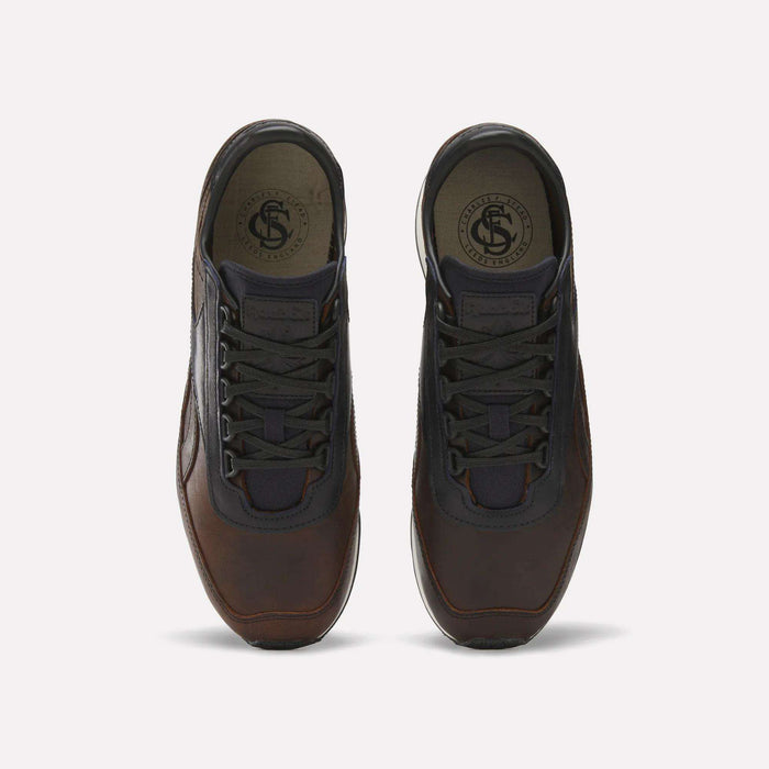 The Reebok Camargue x C.F. Stead Shoes feature brown full-grain leather, black laces, and dark mesh accents, shown from above on a plain light background.