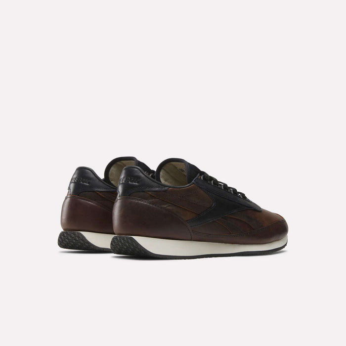 The Reebok Camargue x C.F. Stead Shoes are brown and black full-grain leather sneakers with white soles, shown from the back and side against a plain light background.