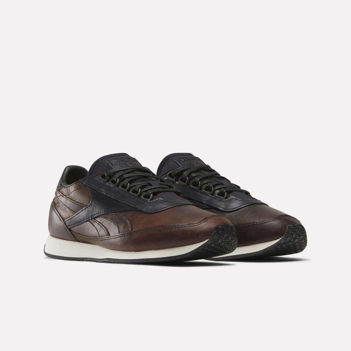 The Reebok Camargue x C.F. Stead Shoes feature full-grain leather uppers, dark navy accents, white midsoles, and black textured outsoles, shown on a plain white background.