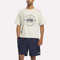 A man wearing a linen Reebok X F45 Training Graphic T-Shirt stands against a plain white background, showcasing a stylish men's fitness shirt by Reebok that's perfect for workouts and casual wear.