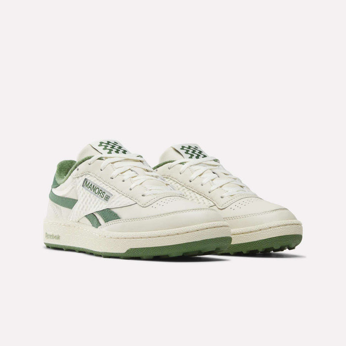 A pair of Reebok x Manors Club C Revenge Golf Shoes in off-white and green, featuring suede accents, textured sides, and Manors branding, photographed against a plain white background.