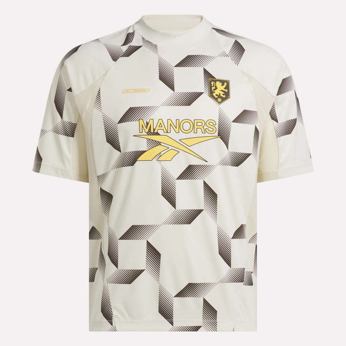 Introducing the Reebok x Manors Men’s Mockneck Polo: a white jersey featuring a bold geometric black pattern, gold MANORS lettering, a gold logo, and a lion crest on the left chest. Designed from performance stretch fabric for exceptional comfort and mobility, this exclusive piece is part of the coveted Reebok x Manors collection.
