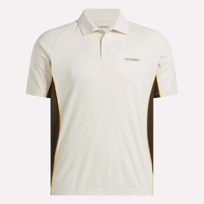 The Reebok x Manors Men’s Polo is a white short-sleeve golf shirt featuring brown side panels, yellow trim, and a small logo on the left chest. Part of the stylish Reebok collection, this men’s golf polo is crafted for comfort and performance on the course.