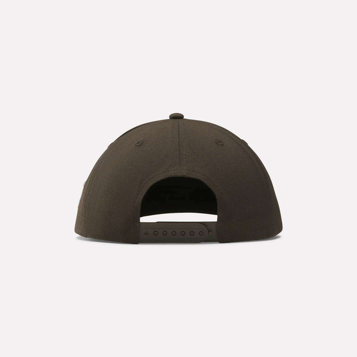 The Reebok x Manors Men’s Retro Crown Cap is a black cap displayed from the back, featuring an adjustable snapback strap with snap closure and showcasing a classic retro crown design.