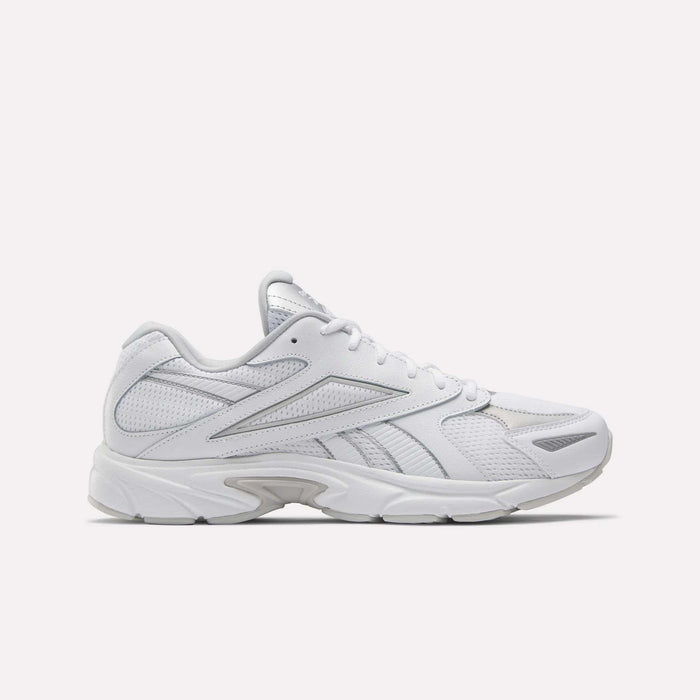 The Reebok Road Prime Shoes, white athletic sneakers with mesh and synthetic overlays, feature subtle gray accents and a chunky sole, capturing Y2K running style; shown in a side profile on a plain white background.